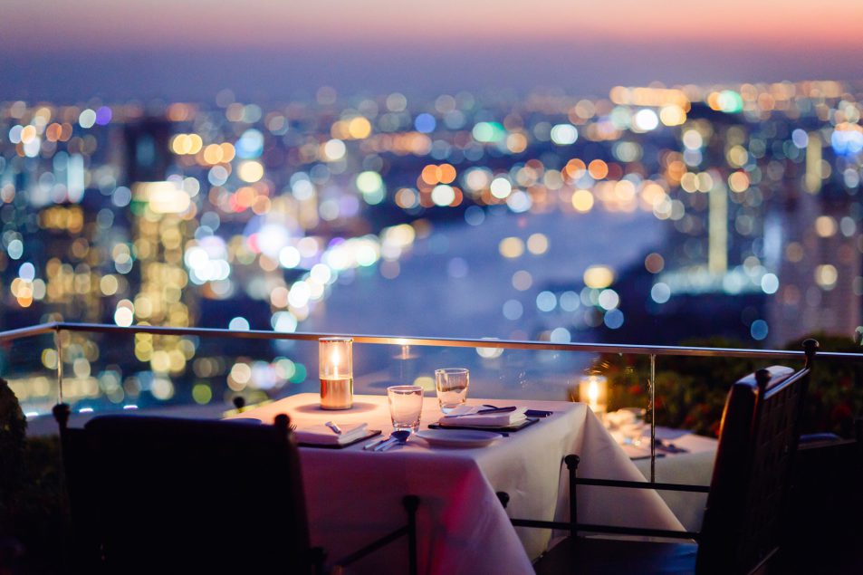 Table at Sirocco with an sunset view of the city