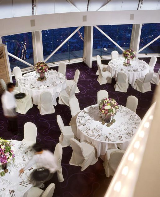ballroom with dinner tables flower centre pieces purple carpet