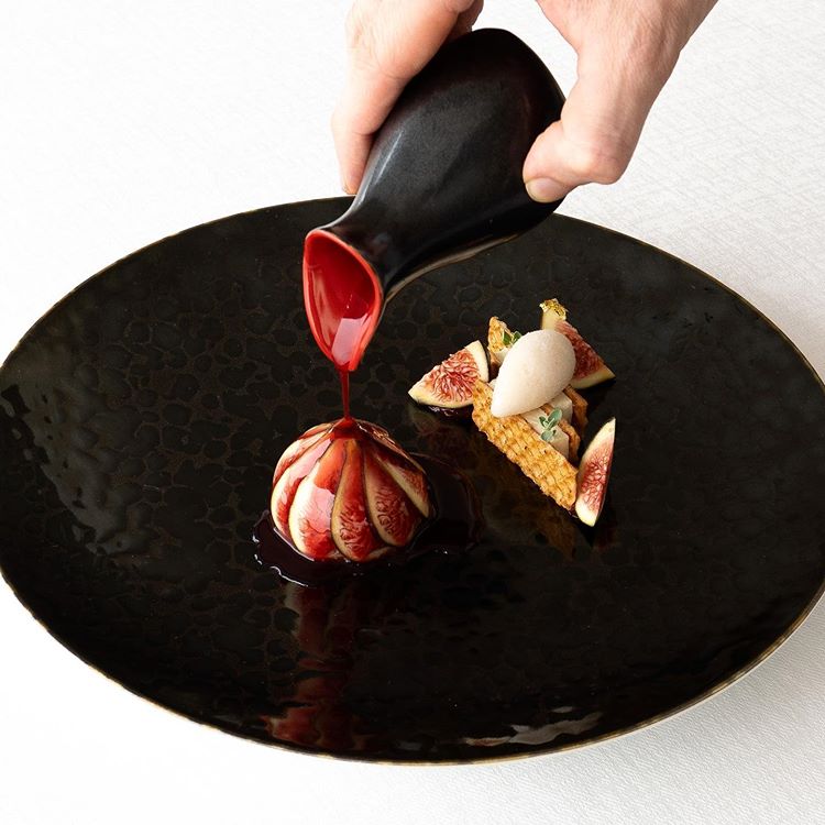 Fig Carpaccio on a black plate