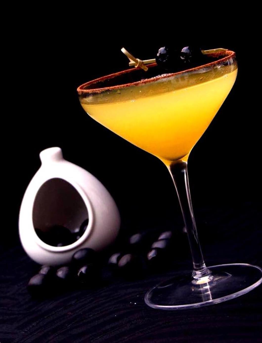 Orange cocktail against dark backdrop